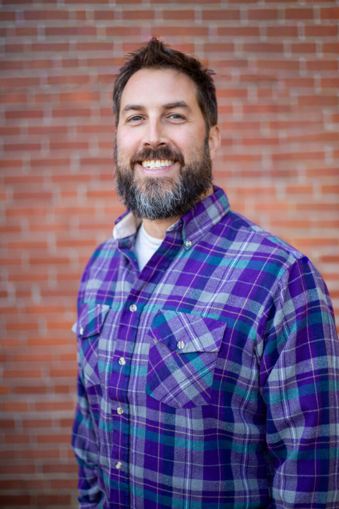 Man in plaid shirt smiling