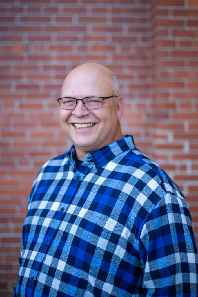 Smiling man in plaid shirt